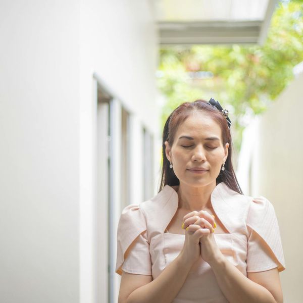 Person meditating calmly with a serene expression.